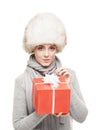 Portrait of a young and beautiful woman in a winter hat with Christmas present Royalty Free Stock Photo