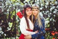 Portrait of young beautiful women smiling in the flowered garden in the spring time. Almond flowers are blooming. The girl is Royalty Free Stock Photo