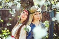 Portrait of young beautiful women smiling in the flowered garden in the spring time. Almond flowers are blooming. The girl is Royalty Free Stock Photo