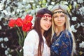 Portrait of young beautiful women smiling in the flowered garden in the spring time. Almond flowers are blooming. The girl is Royalty Free Stock Photo