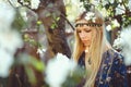 Portrait of young beautiful women smiling in the flowered garden in the spring time. Almond flowers are blooming. The girl is Royalty Free Stock Photo