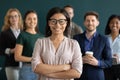 Portrait of young biracial female leader member of corporate team Royalty Free Stock Photo