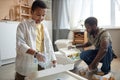 Black Boy Sorting Waste at Home with Father Royalty Free Stock Photo