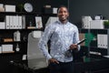 Portrait of young black businessman with financial documents in his hands standing near table in office Royalty Free Stock Photo