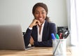 Young black businesswoman sitting at office desk Royalty Free Stock Photo