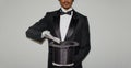 Portrait of young black Illusionist magician doing magic with a top hat Royalty Free Stock Photo