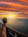 Portrait of a young black male tourist on the deck of a cruise ship in front of a sunset sky. African tourist on the beach trip Royalty Free Stock Photo