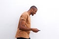 Young black man enjoying music on mobile phone against white background Royalty Free Stock Photo