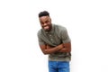 Young black man laughing with arms crossed against white background Royalty Free Stock Photo