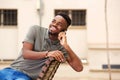 Young black man smiling and talking on mobile phone outside Royalty Free Stock Photo