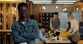 Portrait of young black smiling successful businessman wearing stylish glasses standing in modern office. Working people Royalty Free Stock Photo