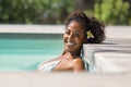 Black beauty woman in swimming pool smiling