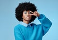Portrait, young and black woman shows peace, sign and with blue studio background, afro and stylish look. Girl, happy Royalty Free Stock Photo