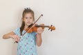 Portrait of a young blond teenage girl playing violin. Girl playing the violin Royalty Free Stock Photo