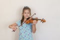 Portrait of a young blond teenage girl playing violin. Girl playing the violin Royalty Free Stock Photo