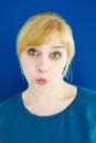 Portrait of young blond woman blowing a kiss Royalty Free Stock Photo