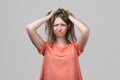 Portrait of young blond woman in panic grabbing her head in fear or frustration. Stress and mental health Royalty Free Stock Photo