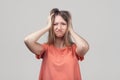 Portrait of young blond woman in panic grabbing her head in fear or frustration. Stress and mental health Royalty Free Stock Photo