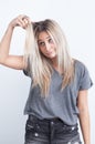 Portrait of a young blond woman playing with her hair Royalty Free Stock Photo
