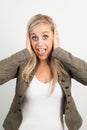 Portrait of a young blond woman smiling and doing a funny face