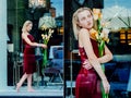 Portrait of the young blonde attractive woman with the iris flowers behind the glass Royalty Free Stock Photo