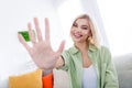 Portrait of young blonde bob hair lady showing five gesture or sending greetings to you welcome  on home loft Royalty Free Stock Photo