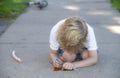 Portrait of a young blonde boy coloring on a sidewalk Royalty Free Stock Photo