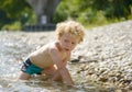 Portrait of a young blonde boy playing in water Royalty Free Stock Photo
