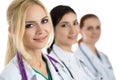 Portrait of young blonde female doctor surrounded by medical tea Royalty Free Stock Photo