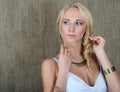 Portrait of a young blonde girl posing in Slavic ethnic jewelry