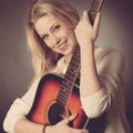 Portrait of young blonde guitar player woman