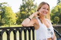 Portrait of a young blonde white girl dressed in a white t-shirt and sunglasses hanging leaning her hand on her chin smiling Royalty Free Stock Photo