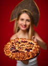 Woman in Russian traditional cap hat kokoshnik happy smiling hold sweet cherry homemade pie tasty bun