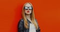 young blonde woman in sunglasses on a red background Royalty Free Stock Photo