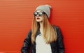 Young blonde woman in sunglasses on a red background Royalty Free Stock Photo