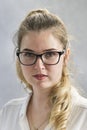 Portrait of young blonde woman wearing glasses. Office worker. Office Manager. Secretary. Scientist