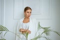 portrait of a young blonde woman in white clothes on the background of a white interior Royalty Free Stock Photo