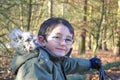 Portrait of young boy on bike in woods