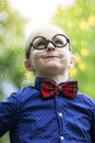 Portrait of young boy with bow tie and big glasses Royalty Free Stock Photo