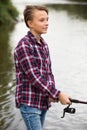 Portrait of young boy casting line for fishing Royalty Free Stock Photo