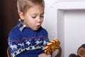 Portrait of a young boy with a delicious large colorful lollipop.