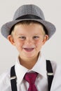 Portrait of a young boy with old hat being funny Royalty Free Stock Photo