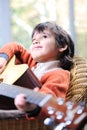 Portrait of young boy playing acoustic guitar Royalty Free Stock Photo