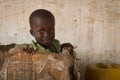 Portrait of a young boy playing in a card box in the town of Nhacra in Guinea Bissau