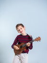 Portrait of a young boy playing the ukelele Royalty Free Stock Photo