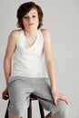 Hes cool and casual. Portrait of a young boy sitting on a stool in the studio. Royalty Free Stock Photo