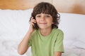 Portrait of young boy using mobile phone in bed Royalty Free Stock Photo