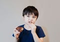 Portrait of Young boy with yummy face enjoy eating roasted chicken for his lunch, Happy kid eating grilled chicken, Healthy food