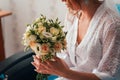 Portrait of a young bride with a bouquet on a light background Royalty Free Stock Photo