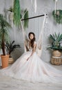 Portrait of a young bride in a fashionable wedding dress with beautiful makeup and hairstyle Royalty Free Stock Photo